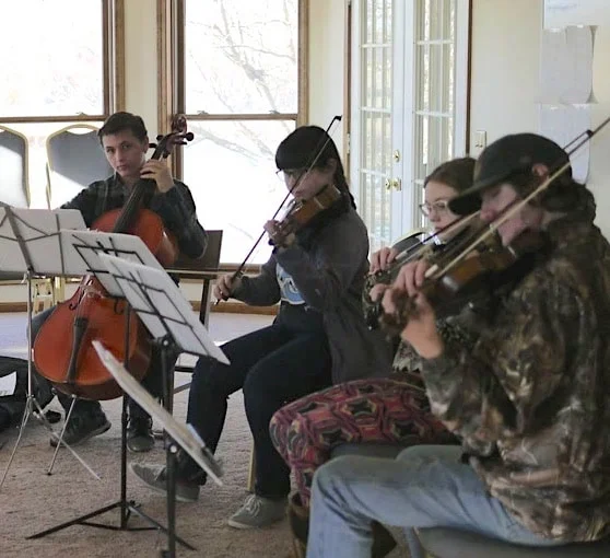 Scholars learning to play musical instruments.